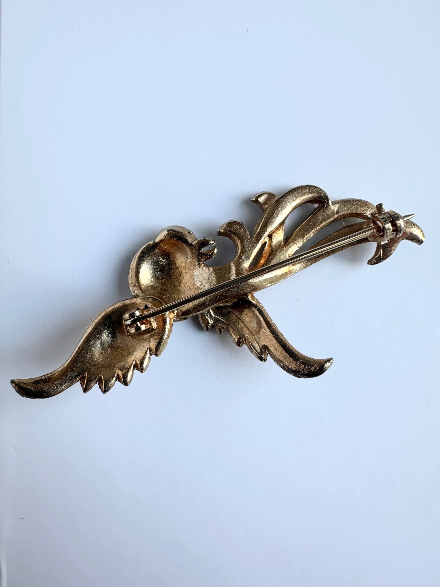 Achterkant van de vergulde vintage broche in de vorm van een phoenix