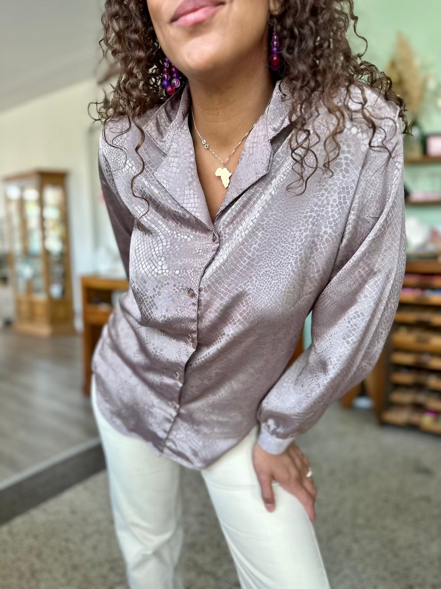 Detailshot van Glanzende vintage blouse in aarde kleur met subtiel slangenmotief
