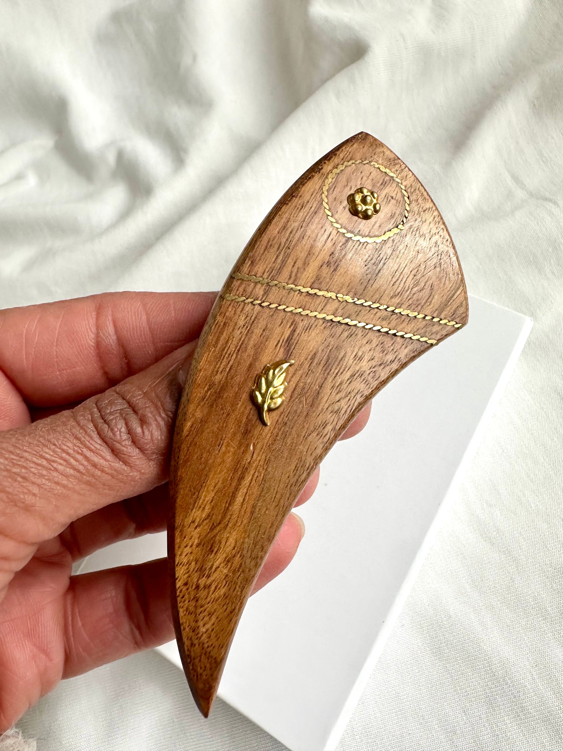 Close-up van houten haarspeld, vintage met gouden versieringen bloem en blad