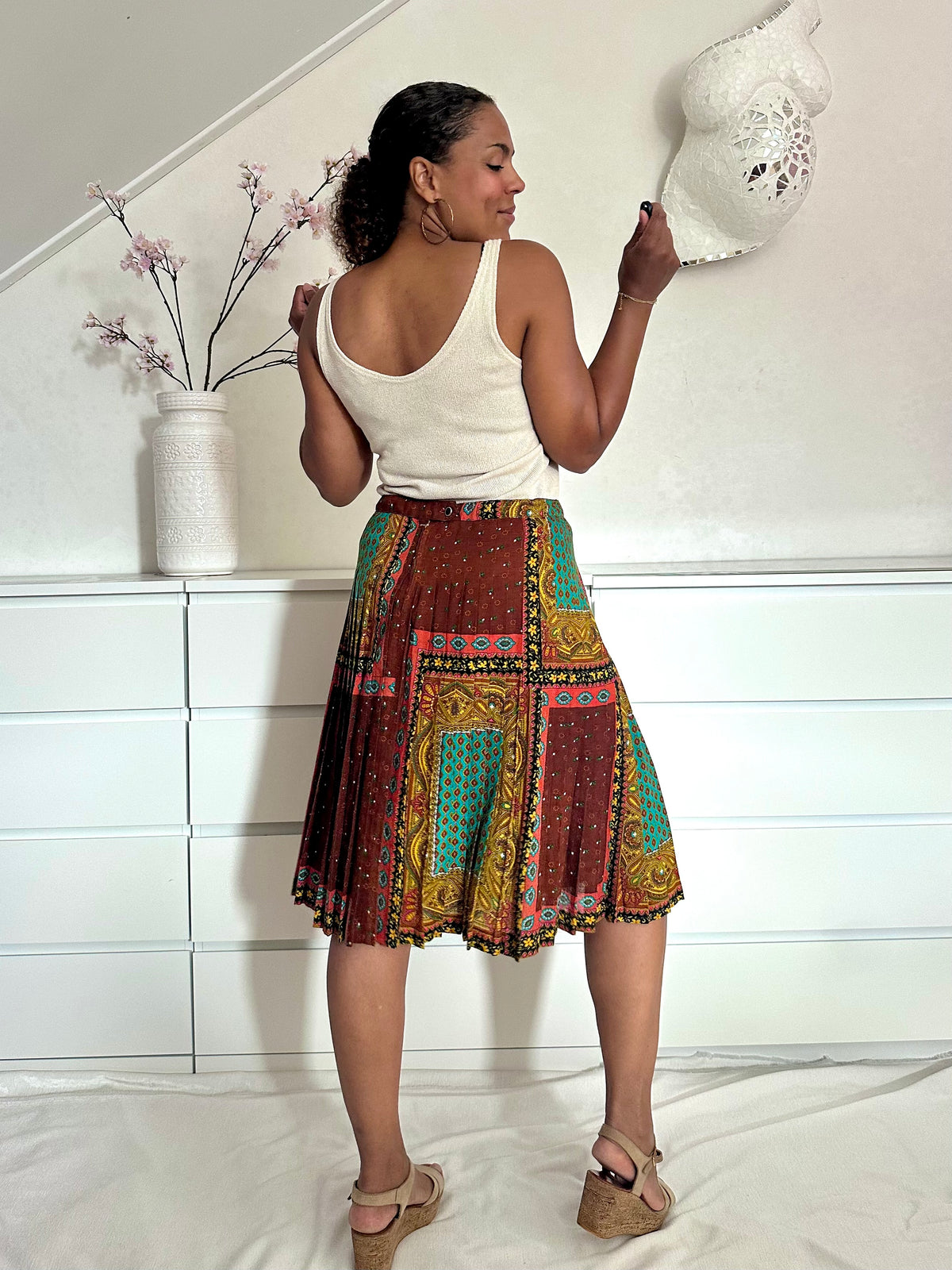 Achterkant van meerkleurige rok met plooien in midi-lengte, retro