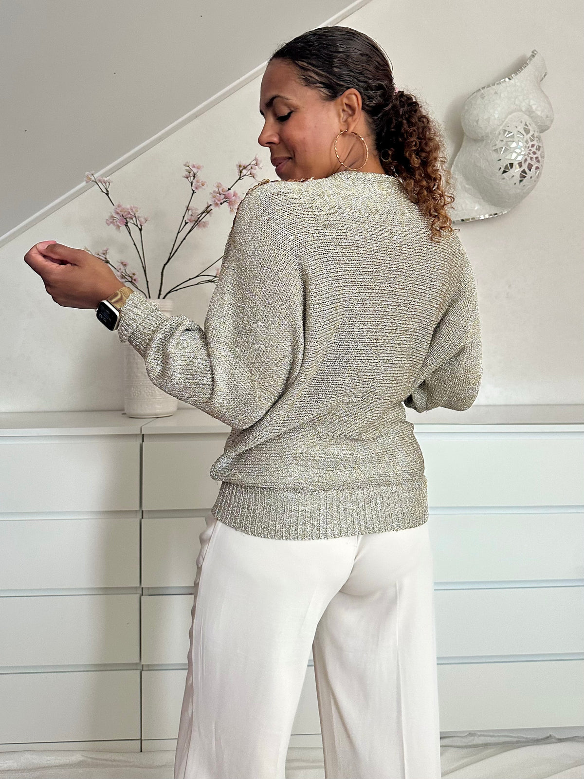 Achterzijde van zilverkleurige vintage lurex top met geborduurde pailletten bloemen en opengewerkt detail bij de hals